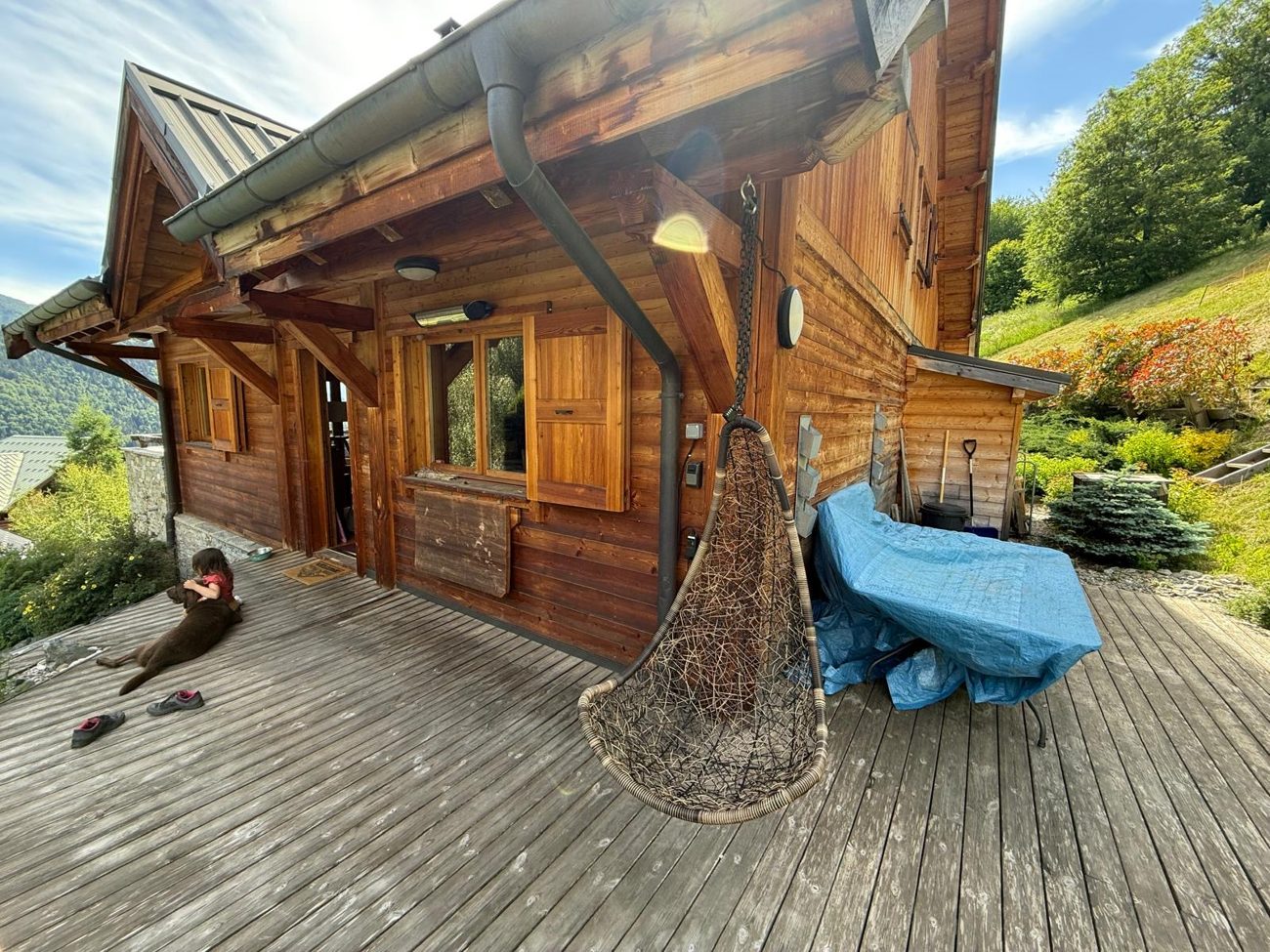 The terrace with the blue tarp covering the furniture